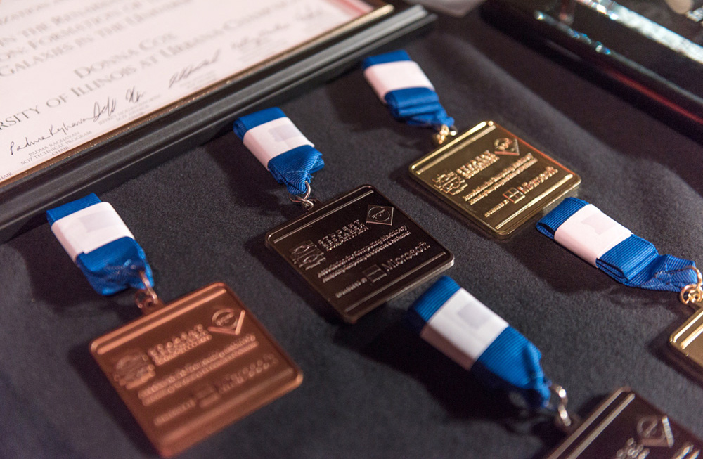 Gold, silver, and bronze medals, with blue ribbons.