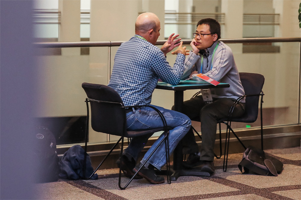 Man is mentored, and listens intently.